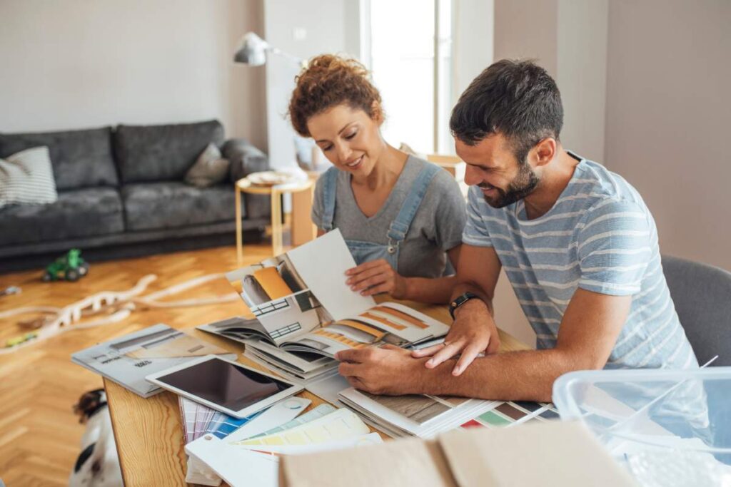 A couple installing a low-flow showerhead in a modern bathroom with natural light.